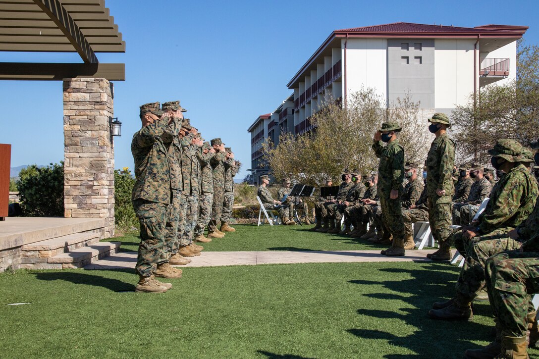 Japan Ground Self-Defense Force (JGSDF) Col. Kazuhiro Irie, center, commanding officer of the 2nd Amphibious Rapid Deployment Regiment, salutes U.S. Marines preparing to be awarded for superior performance during exercise Iron Fist 2022 as part of the closing ceremony at Marine Corps Base Camp Pendleton, California, Feb. 16, 2022. For almost two decades the U.S. Marine Corps, U.S. Navy, and JGSDF have conducted exercise Iron Fist, training together in amphibious operations and affirming the U.S. commitment to our allies. (U.S. Marine Corps photo by Cpl. Aidan Hekker)