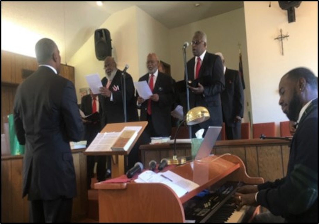 DeJuan Carter (facing the choir) directing the Cross Street Christian Church annual Men’s Day Choir.