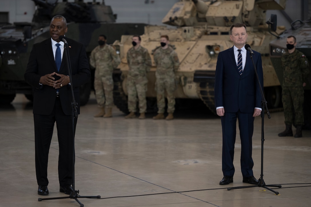 Two leaders speak to troops.