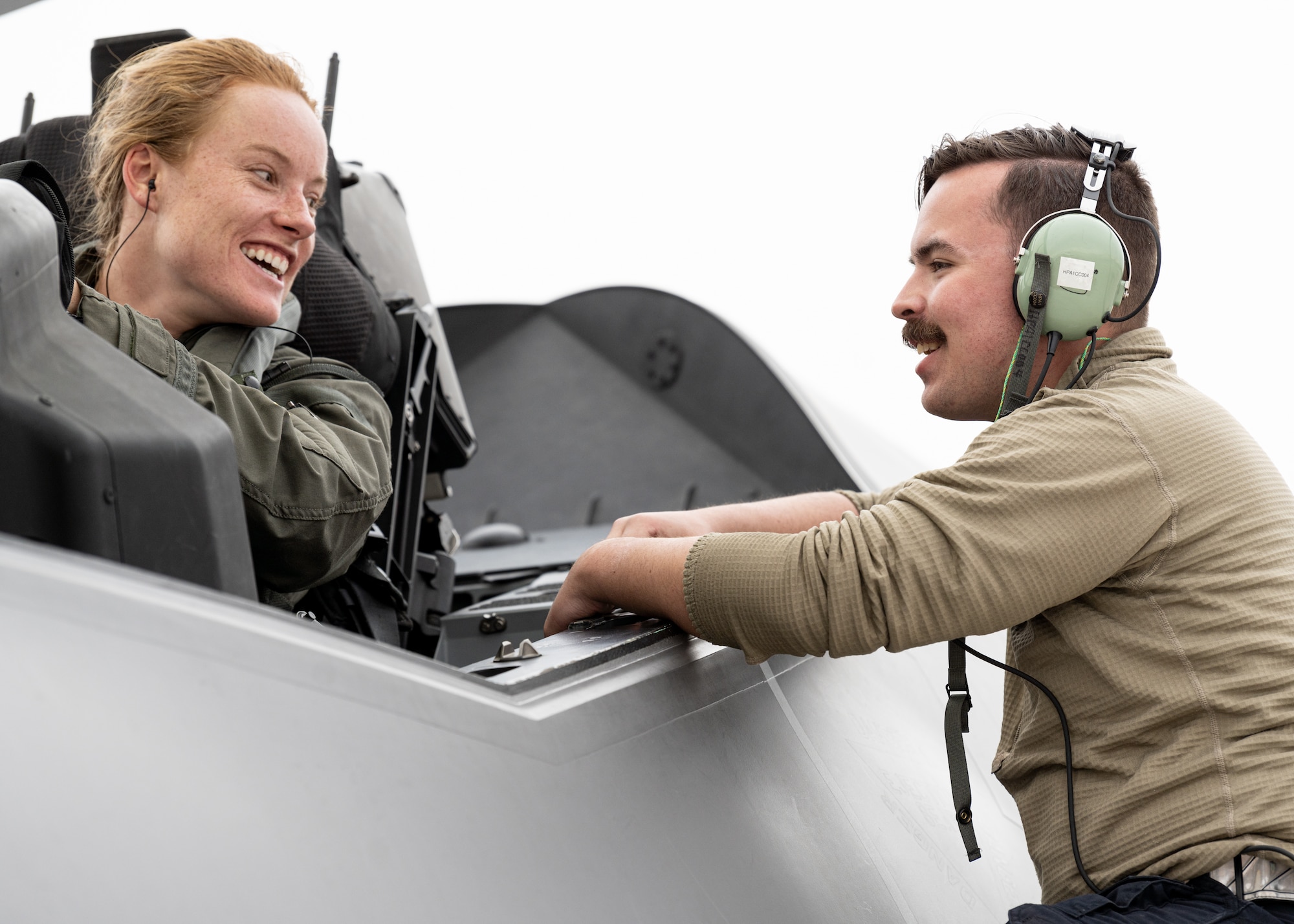 a photo of an F-35 pilot and maintainer talking