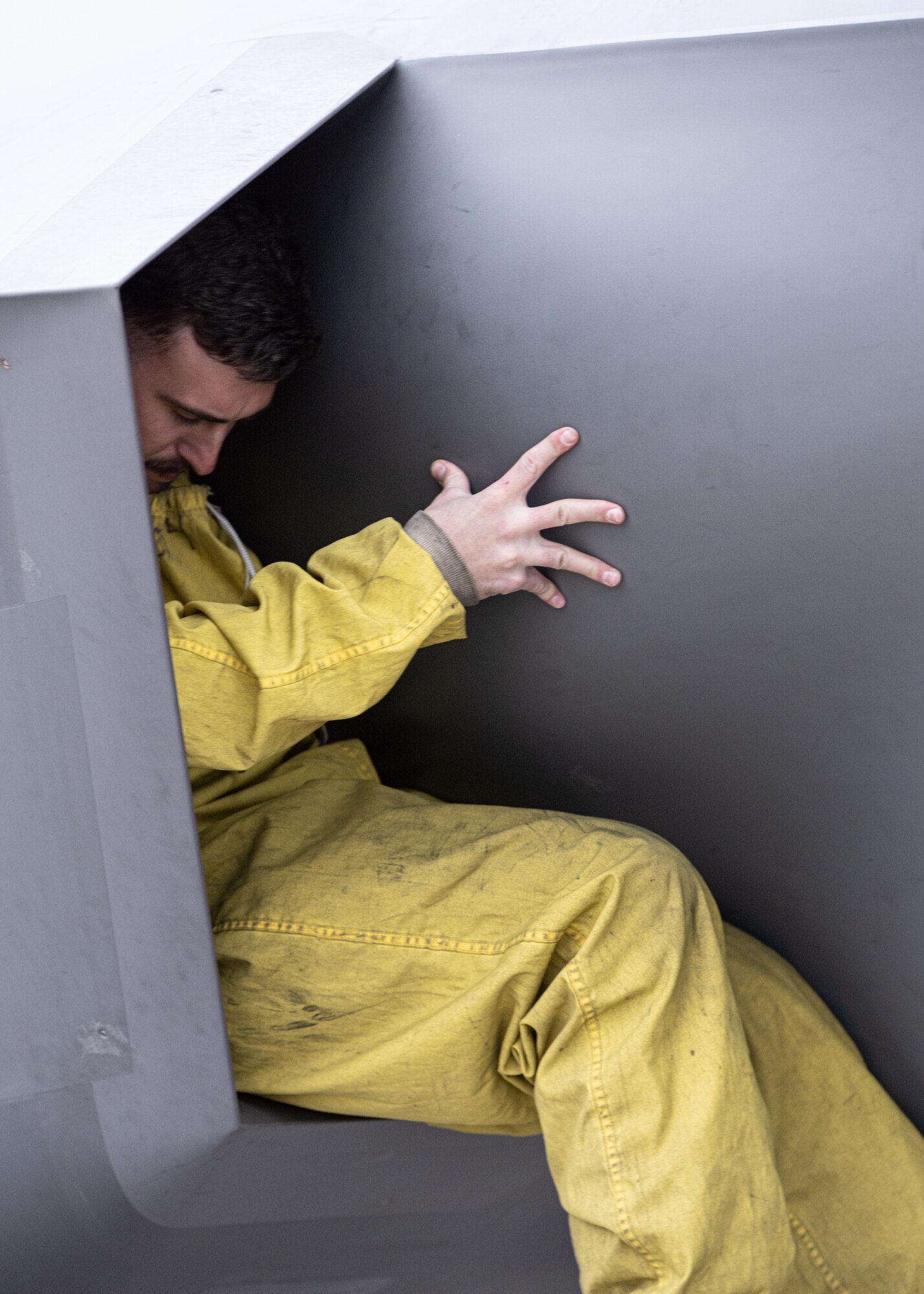 a photo of a maintainer climbing out of an F-35A intake