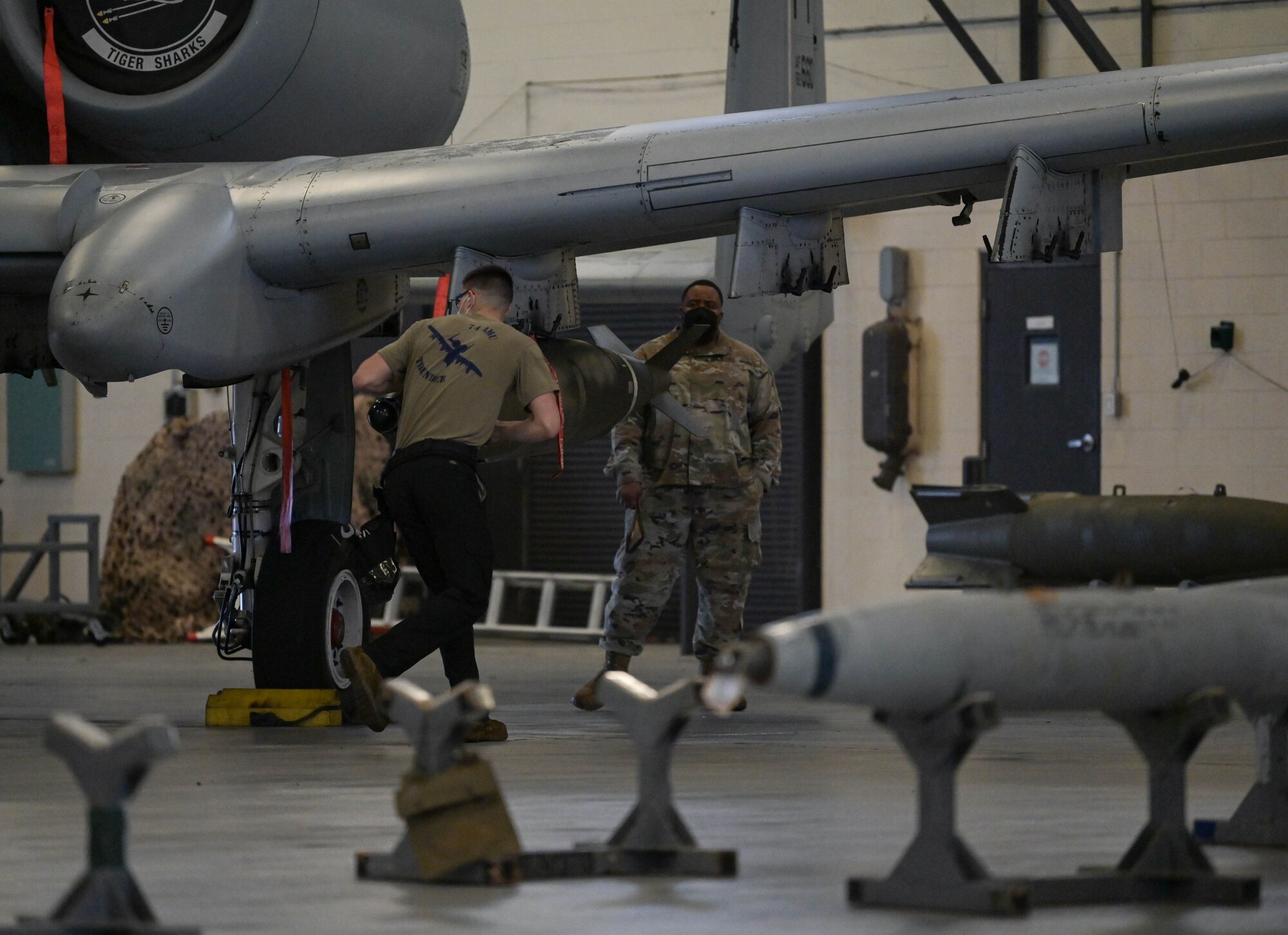 U.S. Air Force Airman 1st Class Steven Mulonet, 74h Fighter Generation Squadron weapons load crew member, runs around an A-10C Thunderbolt II to prepare the aircraft for weapons loading at Moody Air Force Base, Georgia, Feb. 4, 2022. Load crews are required to maintain their proficiency in loading weapons on aircraft safely and efficiently. (U.S. Air Force photo by Senior Airman Rebeckah Medeiros)