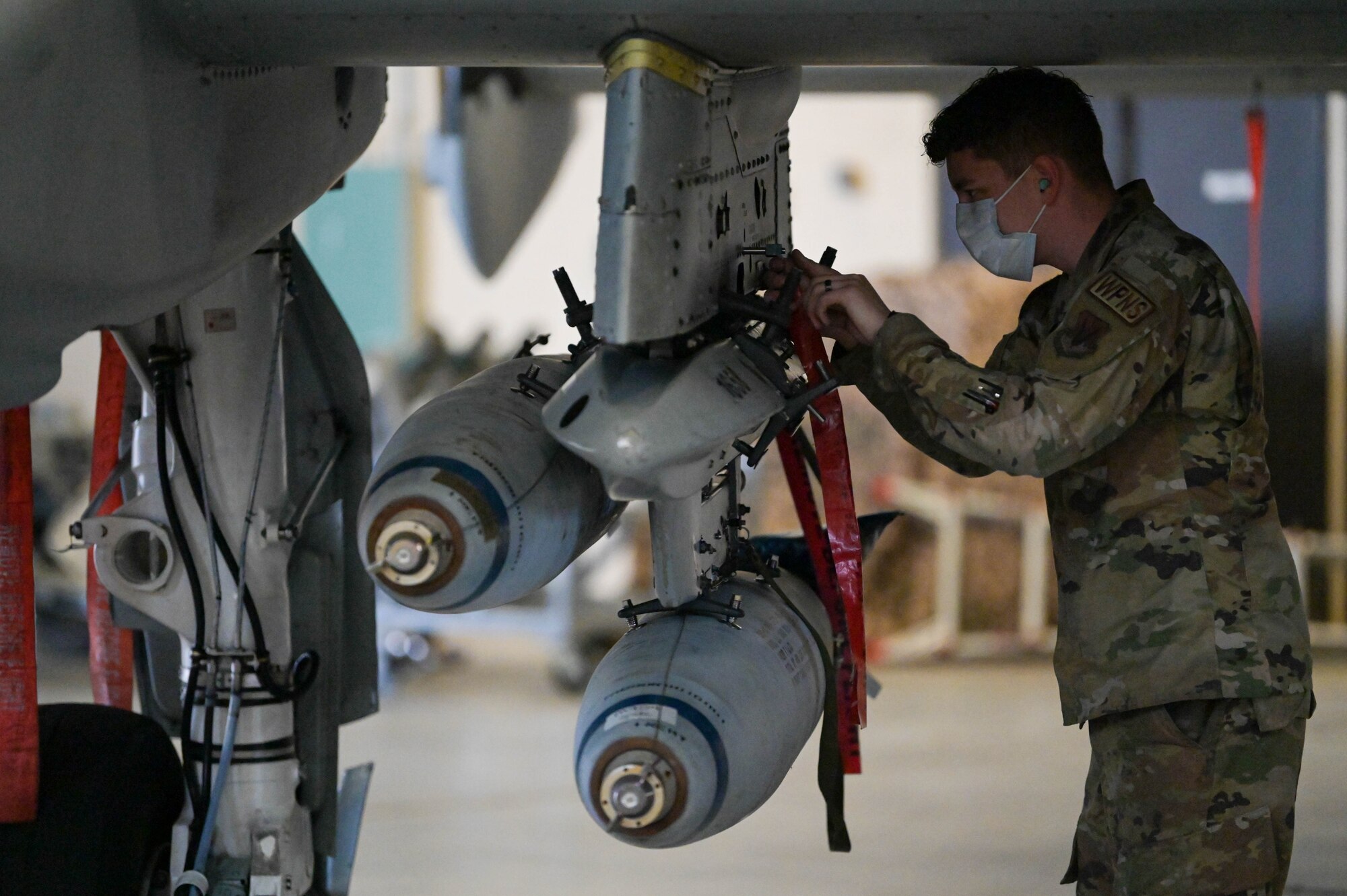 U.S. Air Force Senior Airman Alec Whitacre, 23rd Aircraft Maintenance Group weapons load crew member, evaluates an A-10C Thunderbolt II weapons at Moody Air Force Base, Georgia, Feb. 4, 2022. Monthly evaluations, spot inspections and quarterly load competitions provide an opportunity to give feedback to load crews. (U.S. Air Force photo by Senior Airman Rebeckah Medeiros)
