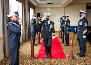 Capt. Brian Hogan, commodore, Submarine Squadron (COMSUBRON) Eight, renders a salute to sideboys