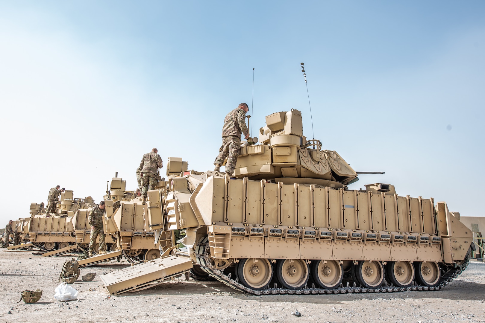 U.S. Soldiers from the 2nd Platoon, Alpha Company, 1/163rd Combined Arms Battalion, inspect Bradley M2A3 Fighting Vehicles at Ali Al Salem AB, Jan. 27, 2022. The vehicle is a light armored, fully tracked transport vehicle, providing cross-country mobility with mounted firepower and protection from artillery and small-arms fire. (U.S. Air National Guard photo by Staff Sgt. Chloe Ochs)