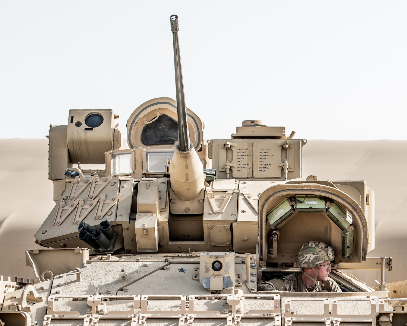A U.S. Soldier from the 2nd Platoon, Alpha Company, 1/163rd Combined Arms Battalion, drives a Bradley M2A3 Fighting Vehicle to its inspection point at Ali Al Salem AB, Jan. 27, 2022. The vehicle is a light armored, fully tracked transport vehicle, providing cross-country mobility with mounted firepower and protection from artillery and small-arms fire. (U.S. Air National Guard photo by Staff Sgt. Chloe Ochs)