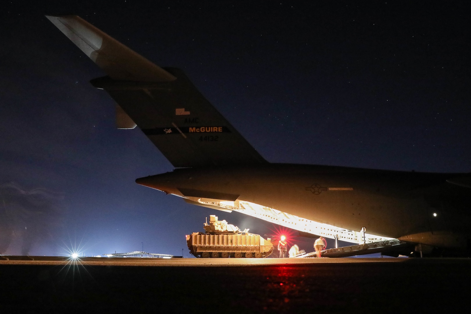 U.S. Soldiers from the 2nd Platoon, Alpha Company, 1/163rd Combined Arms Battalion, unload M2A3 Bradley Fighting Vehicles off a U.S. Air Force C-17 Globemaster in northeast Syria on Jan. 31, 2022. The BFVs provide increased force protection for Combined Joint Task Force - Operation Inherent Resolve and their partner forces as they continue to ensure the enduring defeat of Daesh. (U.S. Army photo by Spc. William Gore)