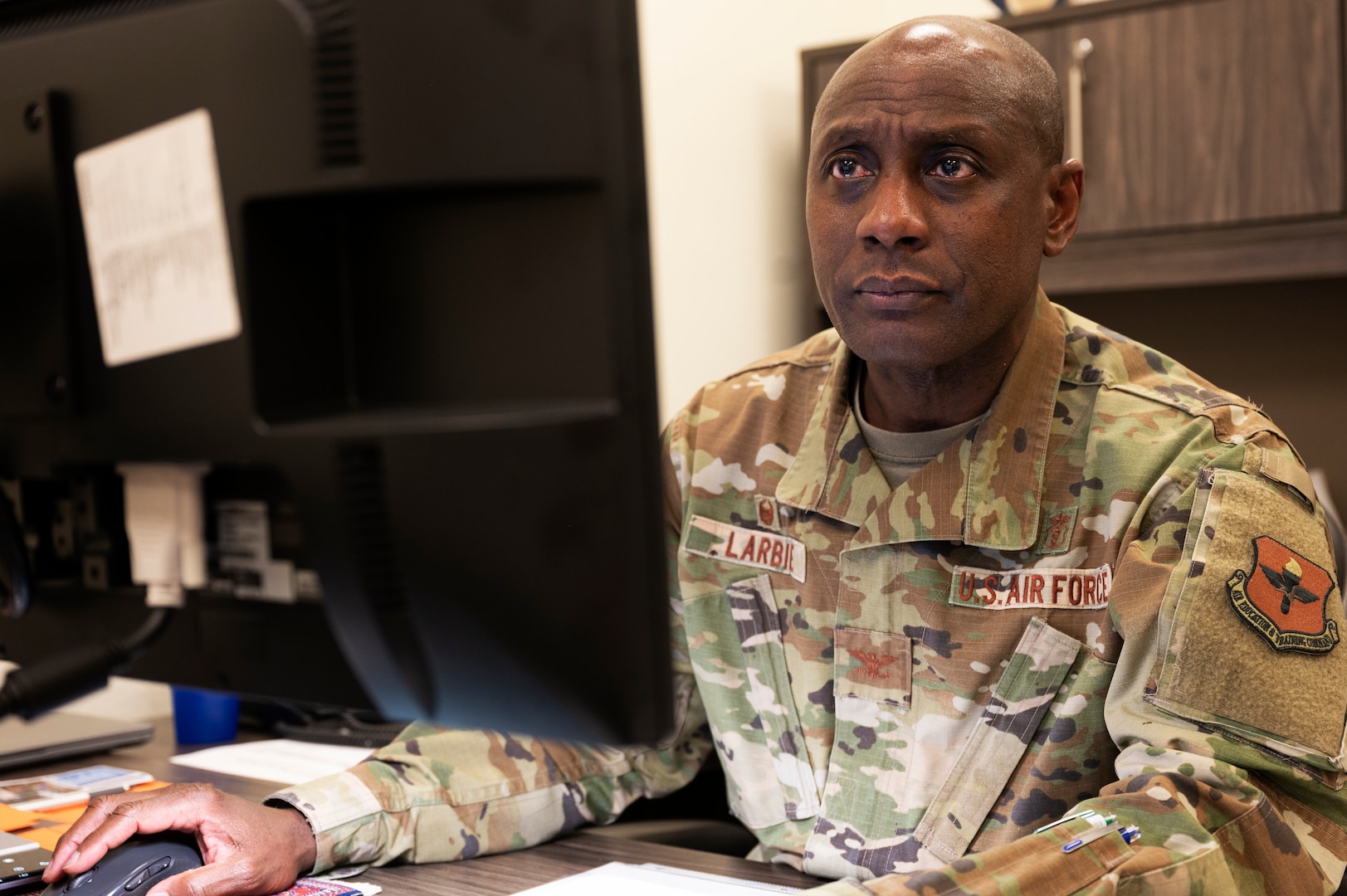 U.S. Air Force Col. Derek Larbie, 17th Medical Group commander, sends an email from his office at the Ross Clinic, Goodfellow Air Force Base, Texas, Feb. 17, 2022. As commander, Larbie oversees the treatment and care of all Goodfellow AFB personnel and their families. (U.S. Air Force photo by, Senior Airman Michael Bowman)