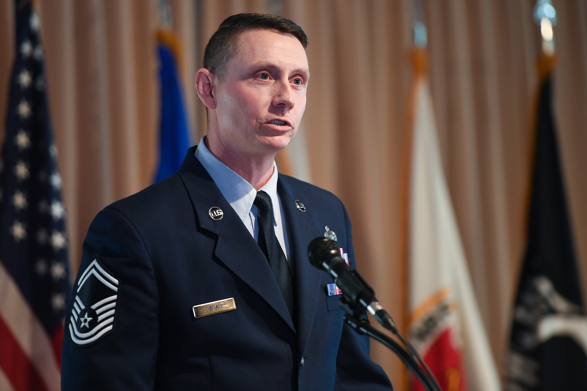 Airman speaking during ceremony