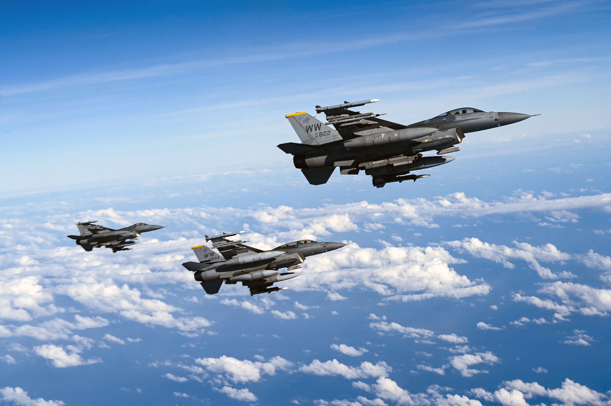 Three U.S. Air Force F-16 Fighting Falcons assigned to the 14th Fighter Squadron, Misawa Air Base, Japan, fly over the Pacific Ocean