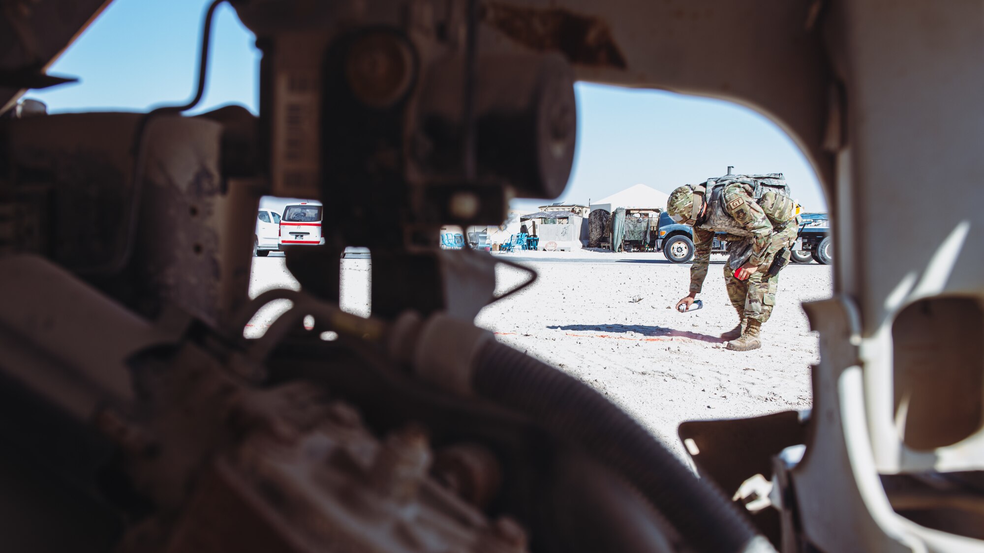 Airmen uses spray paint on the ground.