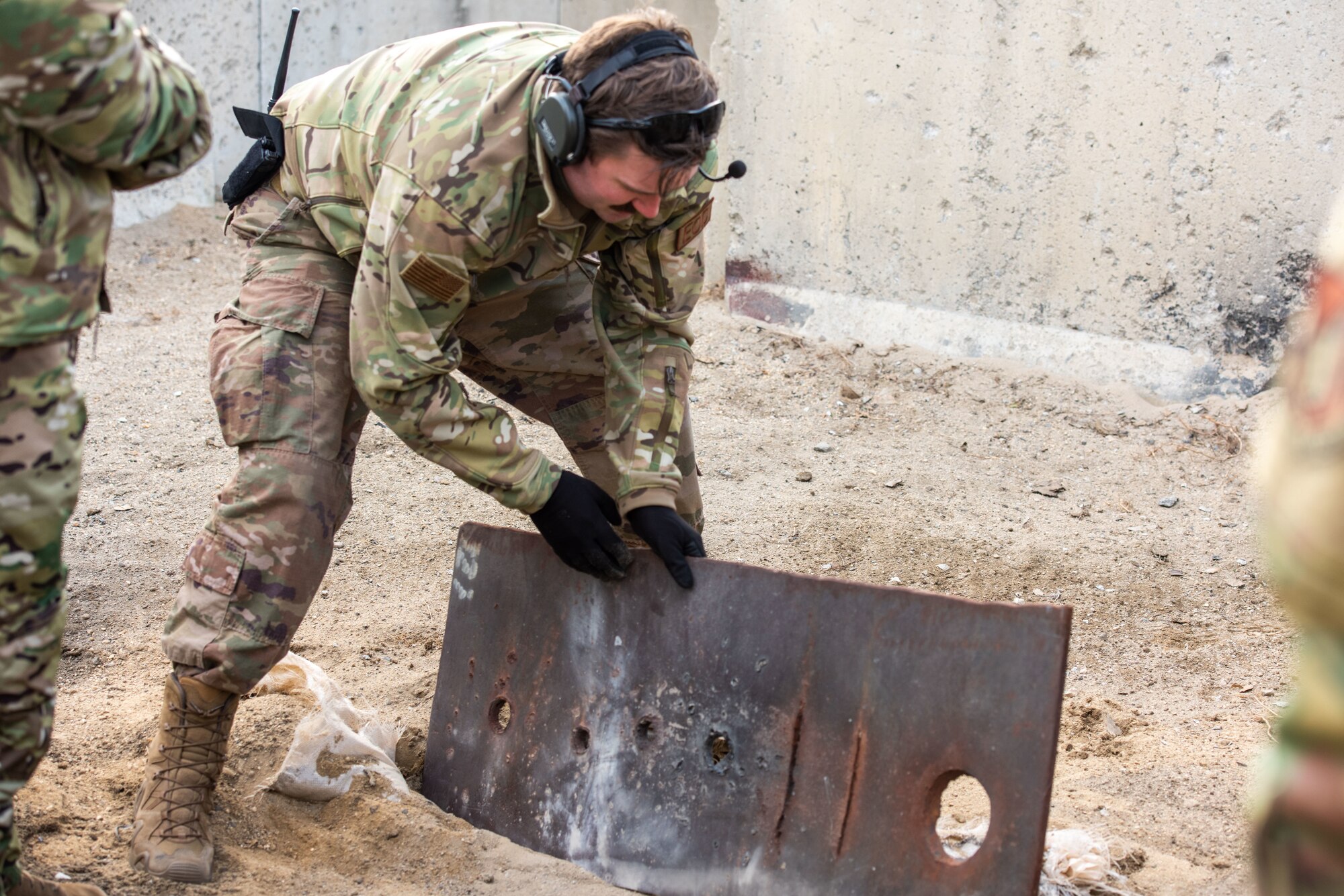 Staff Sgt. Ryan Burks, 51st Civil Engineer Squadron Explosive Ordnance Disposal (EOD) operations non-commissioned officer in charge, displays the aftermath of a test explosion
