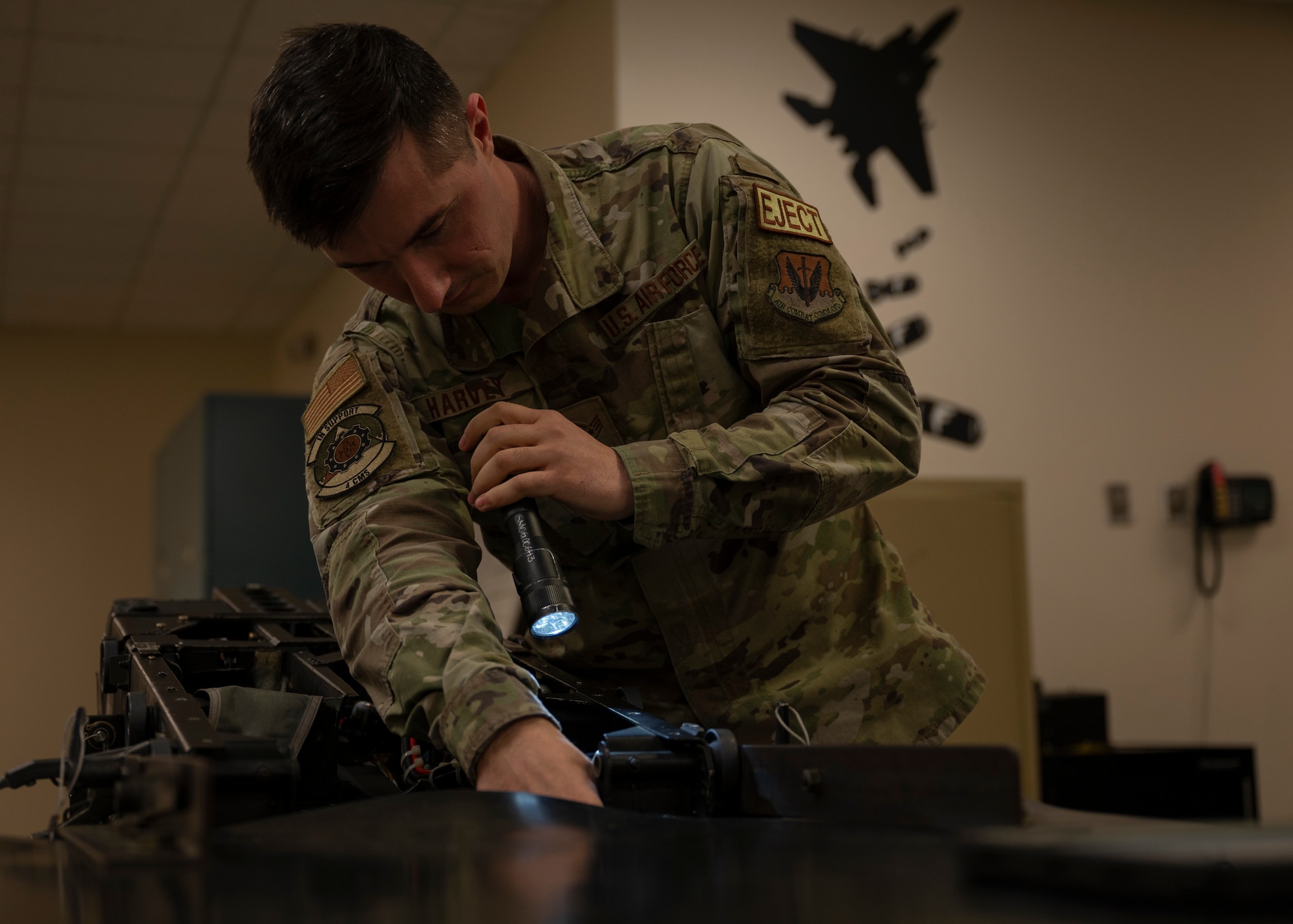 Staff Sgt. Marshall Harvey, 4th Components Maintenance Squadron aircrew egress systems technician, inspects an F-15E Strike Eagle ejection seat at Seymour Johnson Air Force Base, North Carolina, Jan. 25, 2022.