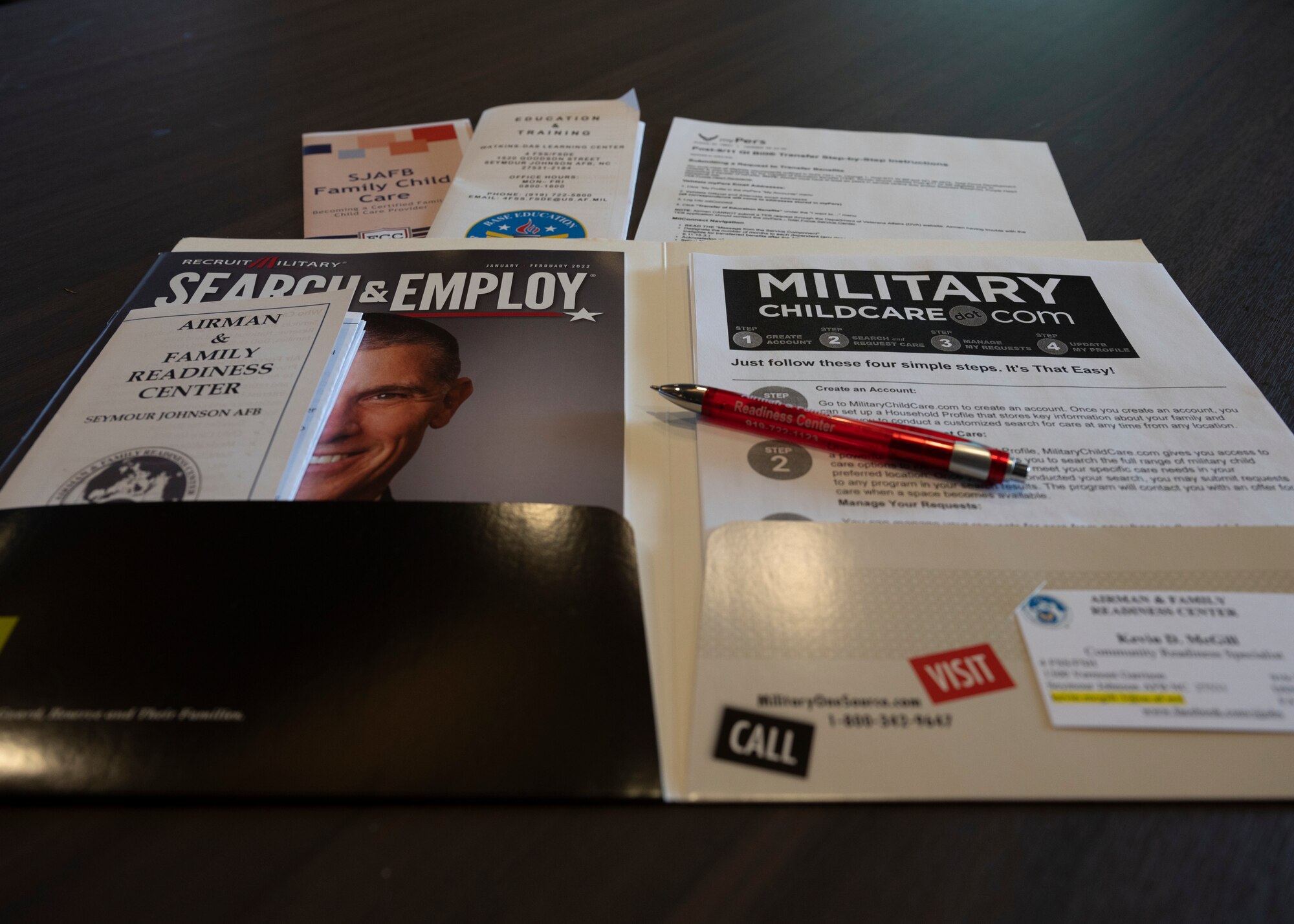 Attendees of the Spouse Education and Employment seminar receive an information folder at Seymour Johnson Air Force Base, North Carolina, Jan. 26, 2022.