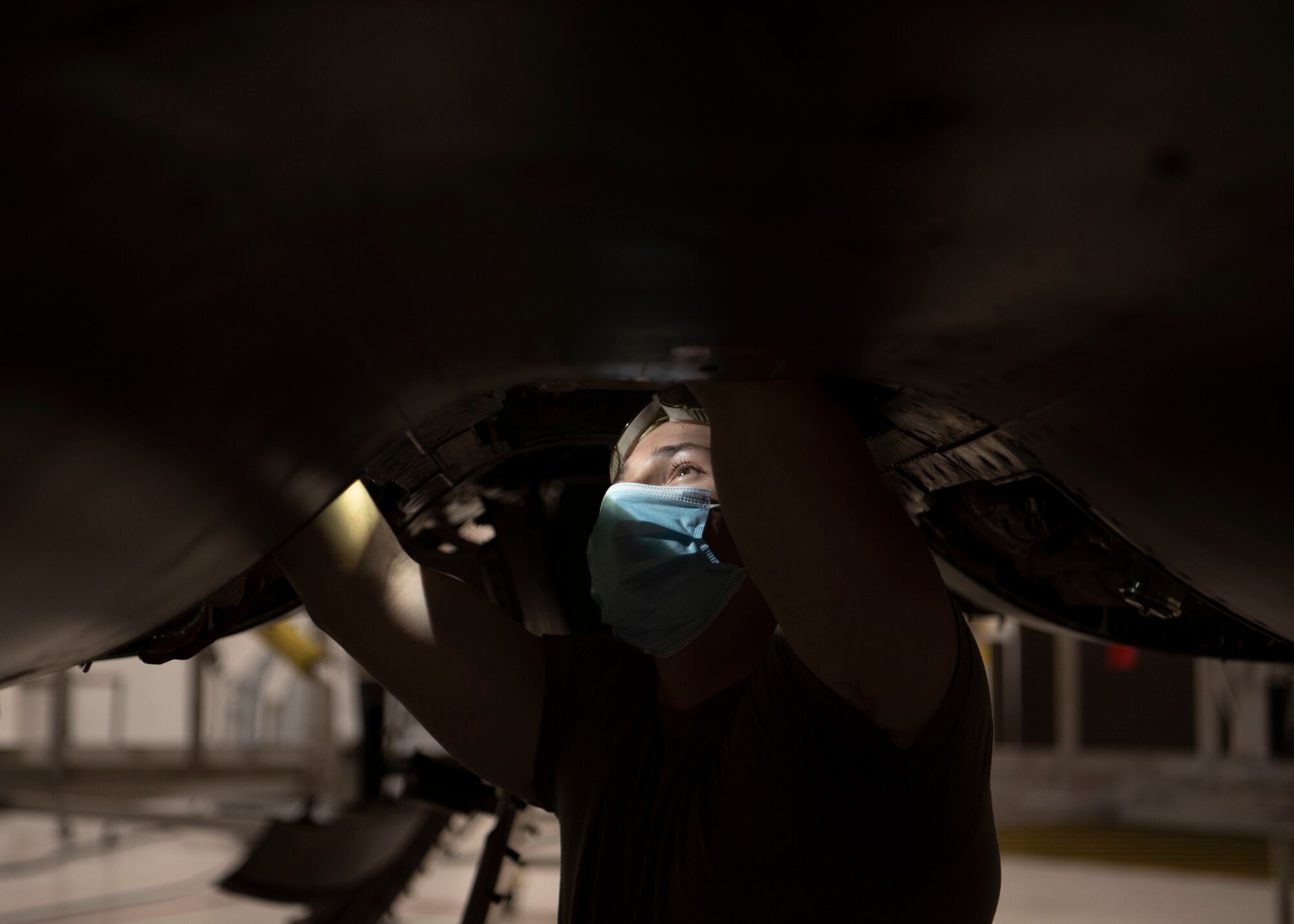 Airman 1st Class Jobe Bertrand, 4th Equipment Maintenance squadron crew chief, inspects the underside of an  F-15E Strike Eagle at Seymour Johnson Air Force Base, North Carolina, Jan. 7, 2022.
