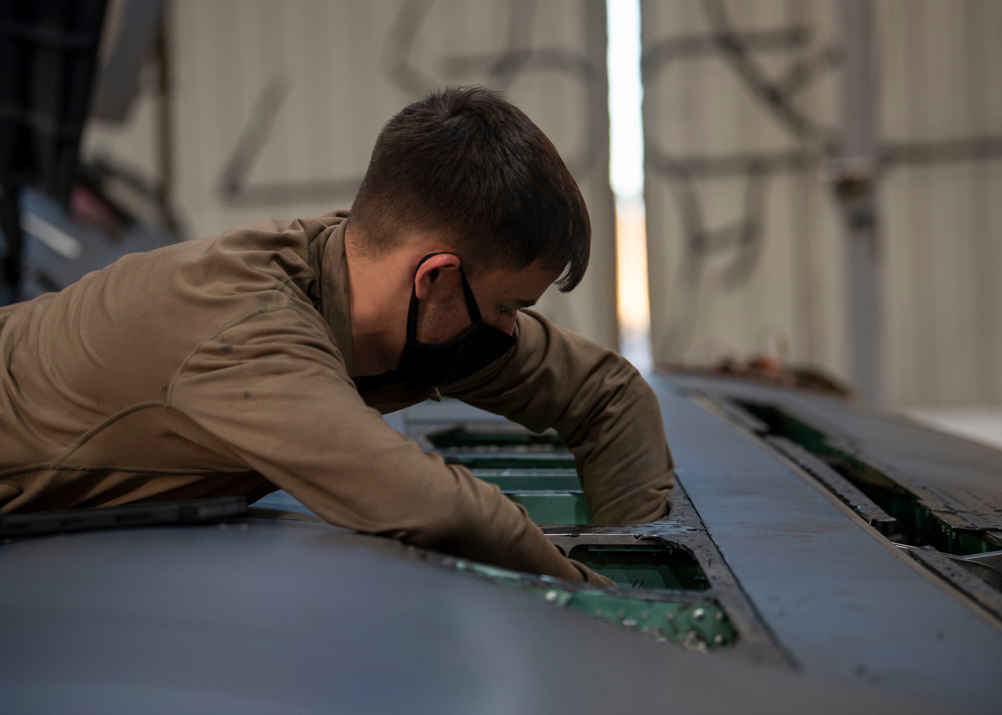 Airman 1st  Class Hayden Gray, 4th Equipment Maintenance Squadron crew chief, performs routine phase maintenance on an F-15E Strike Eagle at Seymour Johnson Air Force Base, North Carolina, Jan. 7, 2022.