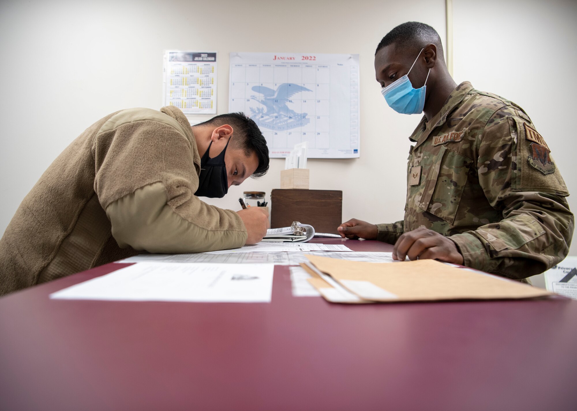 Senior Airman Raymart Montalban, left, 4th Civil Engineer Squadron heavy equipment technician, receives an outprocessing brief from Senior Airman Tyree Bynum, 4th Logistics Readiness Squadron personal property clerk, at Seymour Johnson Air Force Base, North Carolina, Jan. 14, 2022.