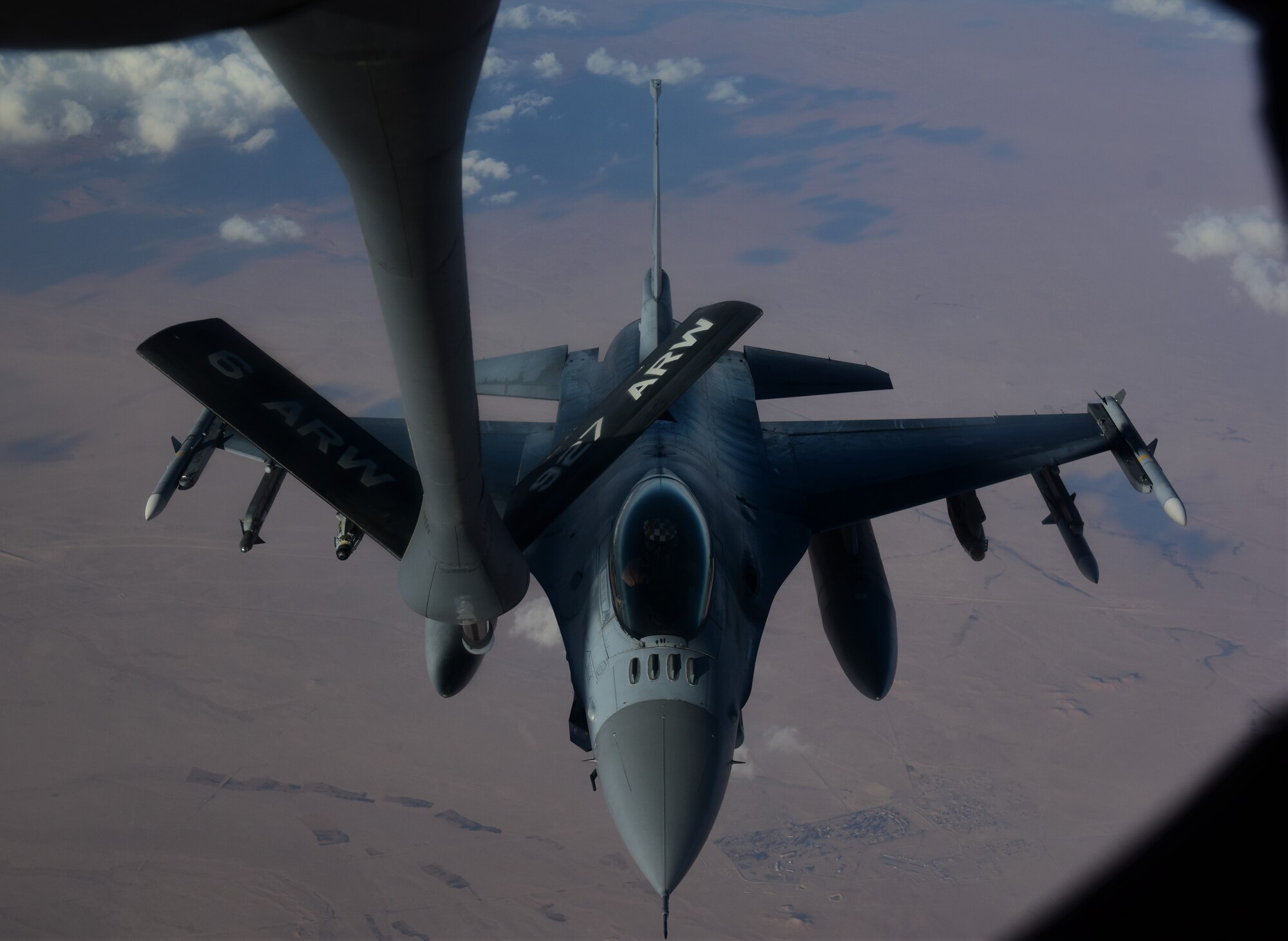 A U.S. Air Force F-16 flies over Southwest Asia in approach to receive a refueling.