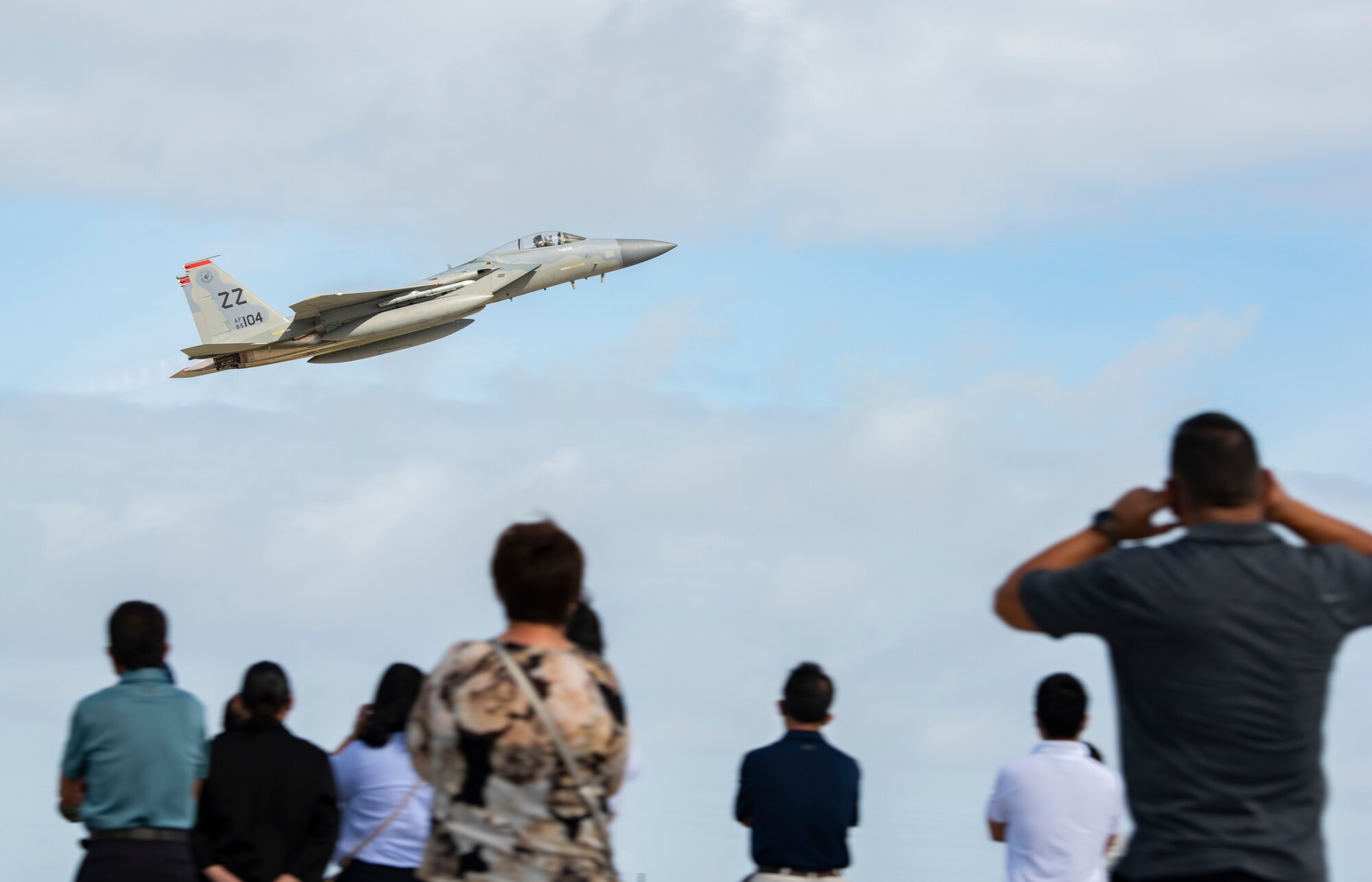 Spectators from the local community watch aircraft take off from Andersen Air Force Base, Guam, during a take-off viewing day for exercise Cope North 22, Feb. 15, 2022. Service members, their families, and local community members were invited to the flight line to learn the importance of Cope North while observing aircraft capabilities.  Exercise Cope North is the U.S. Pacific Air Forces’ largest multilateral exercise and includes more than 2,500 U.S. Airmen, Marines, and Sailors working alongside 1,000 combined Japan Air Self-Defense Force and Royal Australian Air Force counterparts. (U.S. Air Force Photo by Senior Airman Helena Owens)