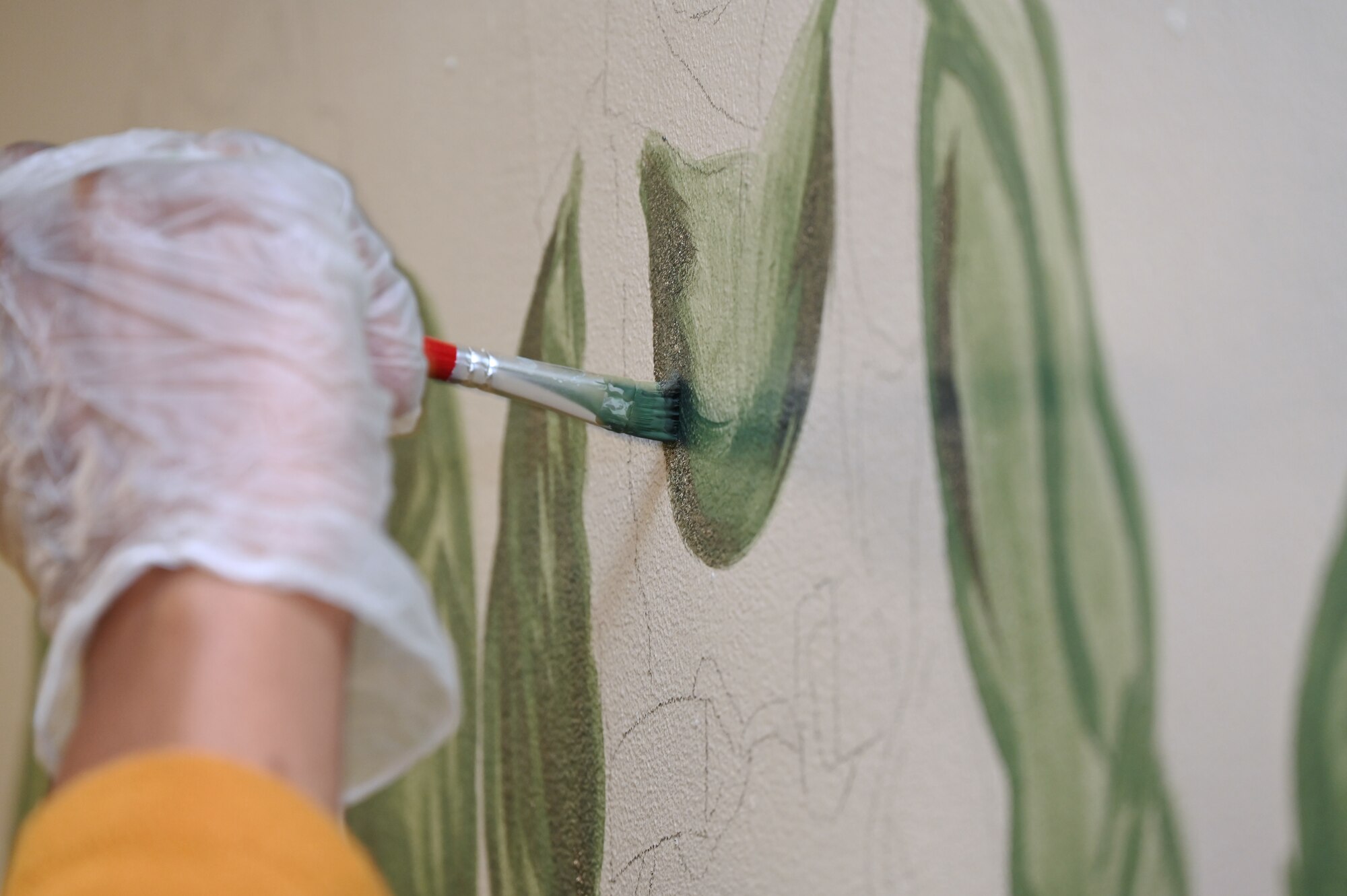 Slim, tall, with a contagious smile, Senior Airman Mia M. Evans, 332d Expeditionary Force Support Squadron services apprentice, incorporates art as a way to carry on the Red Tail legacy.