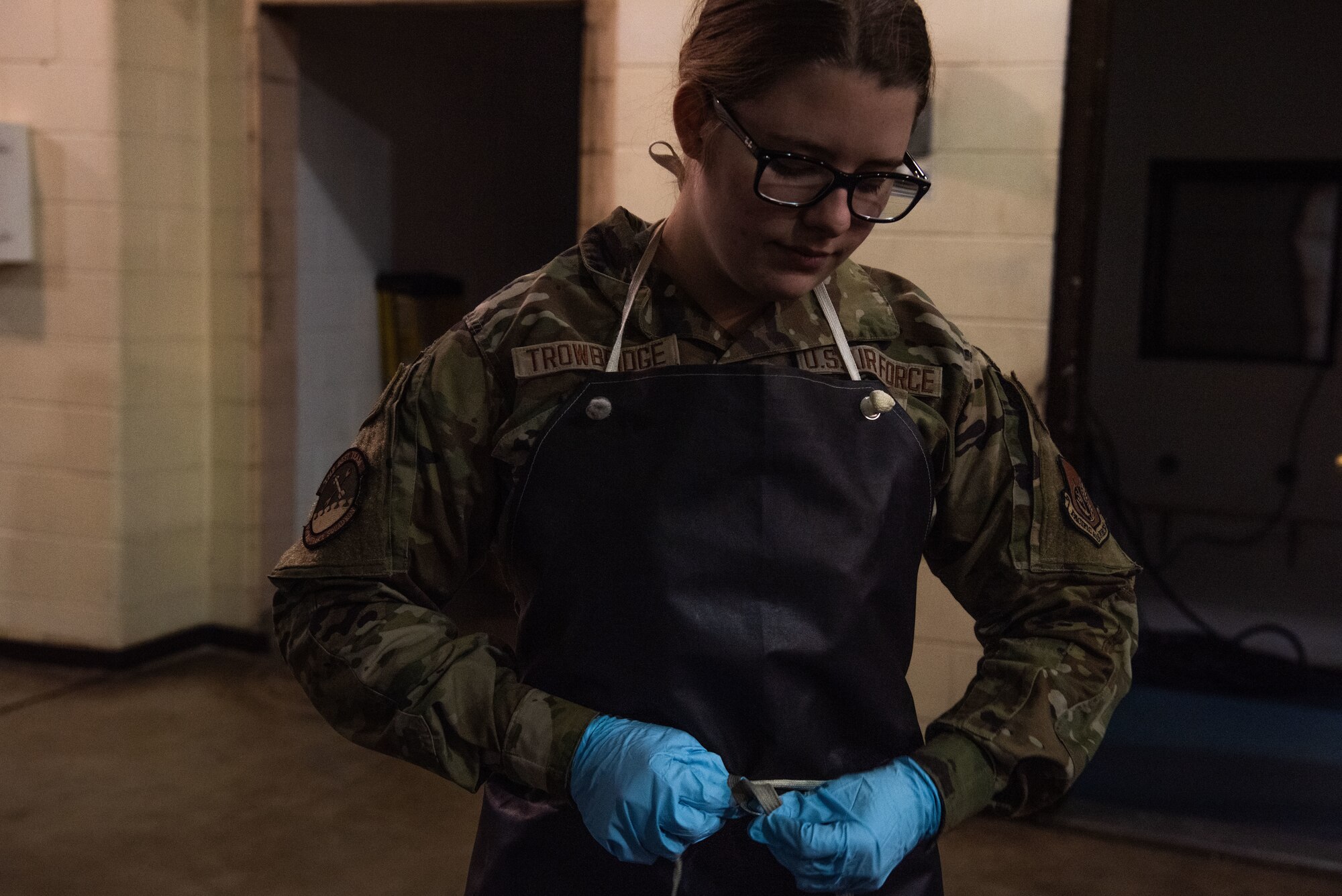 Airman 1st Class Hunter Trowbridge, 51st Maintenance Squadron Nondestructive Inspection (NDI) apprentice, dons her personal protective equipment at Osan Air Base, Republic of Korea, Feb. 17, 2022.