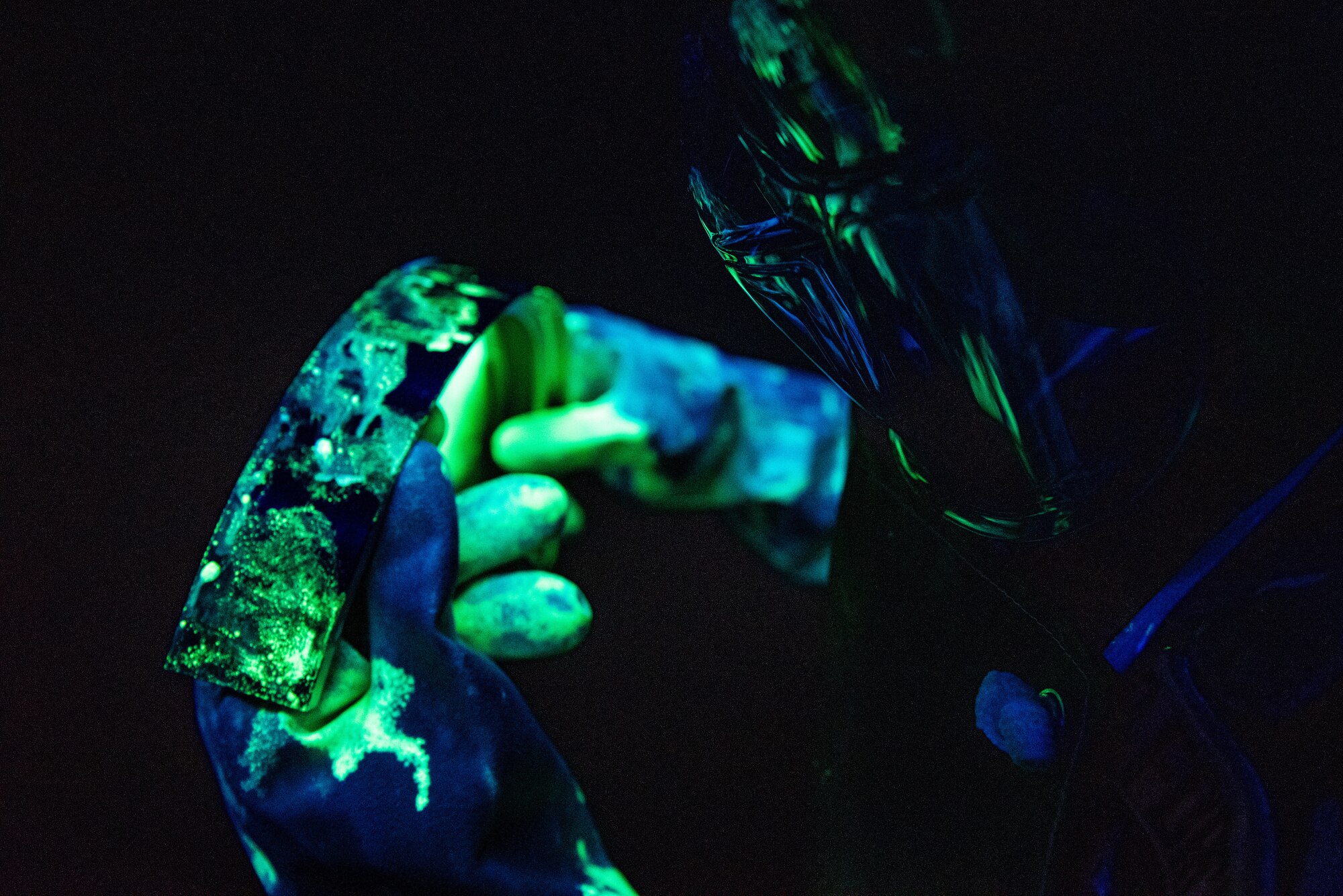 Airman 1st Class Hunter Trowbridge, 51st Maintenance Squadron Nondestructive Inspection (NDI) apprentice, examines an aircraft part for cracks and other discontinuities at Osan Air Base, Republic of Korea, Feb. 17, 2022.