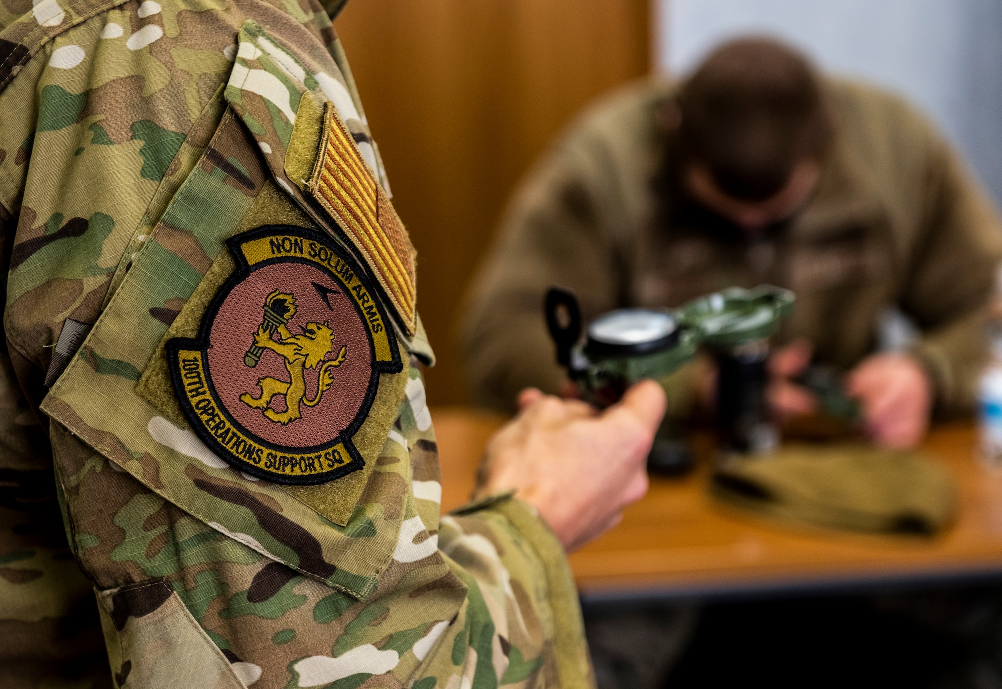 U.S. Air Force Tech. Sgt. Mark Mitchell, 100th Operations Support Squadron Survival, Evasion, Resistance, and Escape NCO in charge of training, teaches members of the 100th Civil Engineer Squadron how to find their location and plot a course on a map using a compass on Royal Air Force Mildenhall, England, Feb. 17, 2022. The classroom portion of this training is where members learn the fundamentals of land navigation before they are led outside to then put their knowledge to the test. (U.S. Air Force photo by Senior Airman Kevin Long)