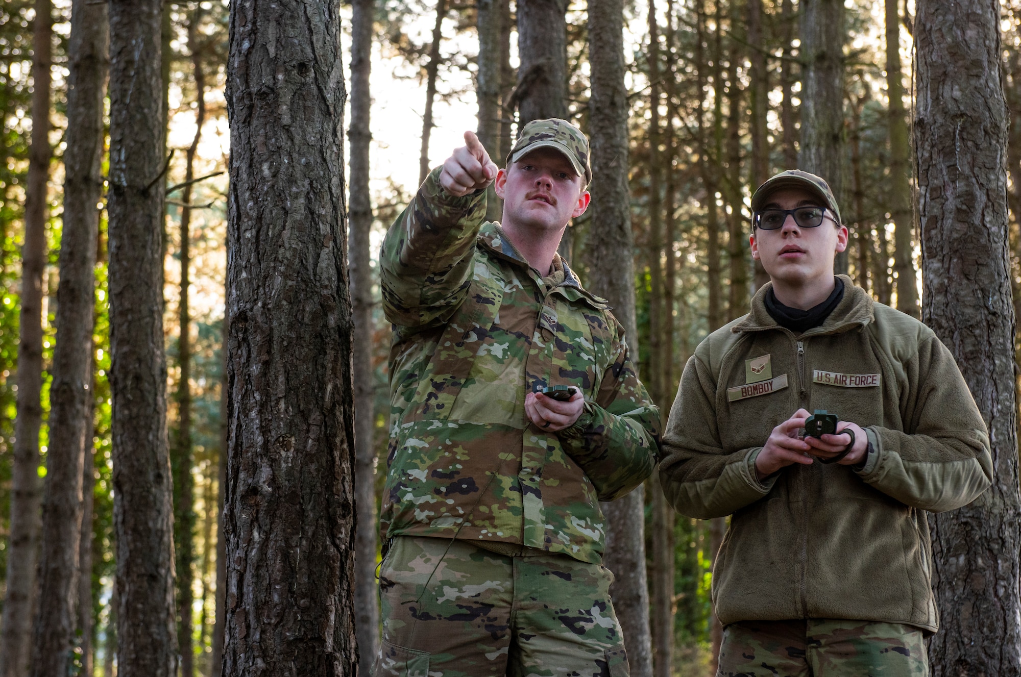 Airmen assigned to the 100th Civil Engineer Squadron navigate through the forest following their recent Survival, Evasion, Resistance, and Escape training on Royal Air Force Mildenhall, England, Feb. 17, 2022. The first part of their training took place inside of the SERE classroom, but now they must practice their new skills and navigate to specific points in the forest using only a compass. (U.S. Air Force photo by Senior Airman Kevin Long)