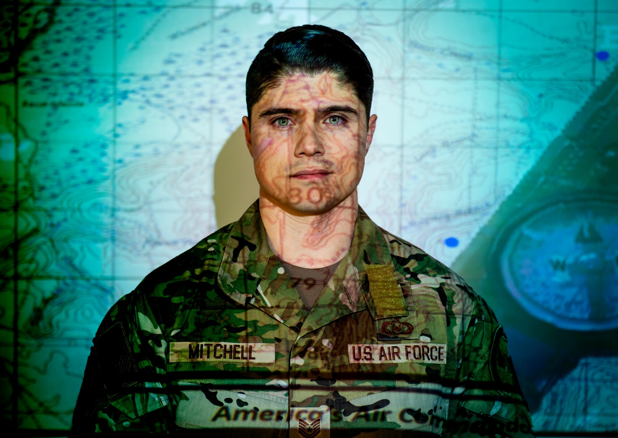 U.S. Air Force Tech. Sgt. Mark Mitchell, 100th Operations Support Squadron Survival, Evasion, Resistance, and Escape NCO in charge of training, poses for a photo after leading a land navigation course on Royal Air Force Mildenhall, England, Feb. 17, 2022. Land navigation training is just one of many courses that Mitchell instructs for members of the 100th Air Refueling Wing to prepare them for various scenarios they may encounter in the field. (U.S. Air Force photo illustration by Senior Airman Kevin Long)