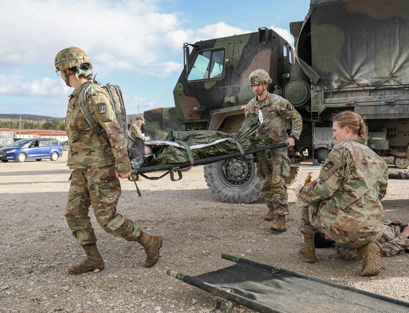 Soldiers of the 547th Medical Company (Area Support), 62nd Medical Brigade, react to a mock accident during a mass casualty training event at the Joint Multinational Readiness Center in Hohenfels, Germany, Feb. 17, 2022. The medical company is in Europe supporting the 116th Infantry Brigade Combat Team, Virginia Army National Guard, as they prepare to deploy to the Balkans in support of the NATO mission in the region.