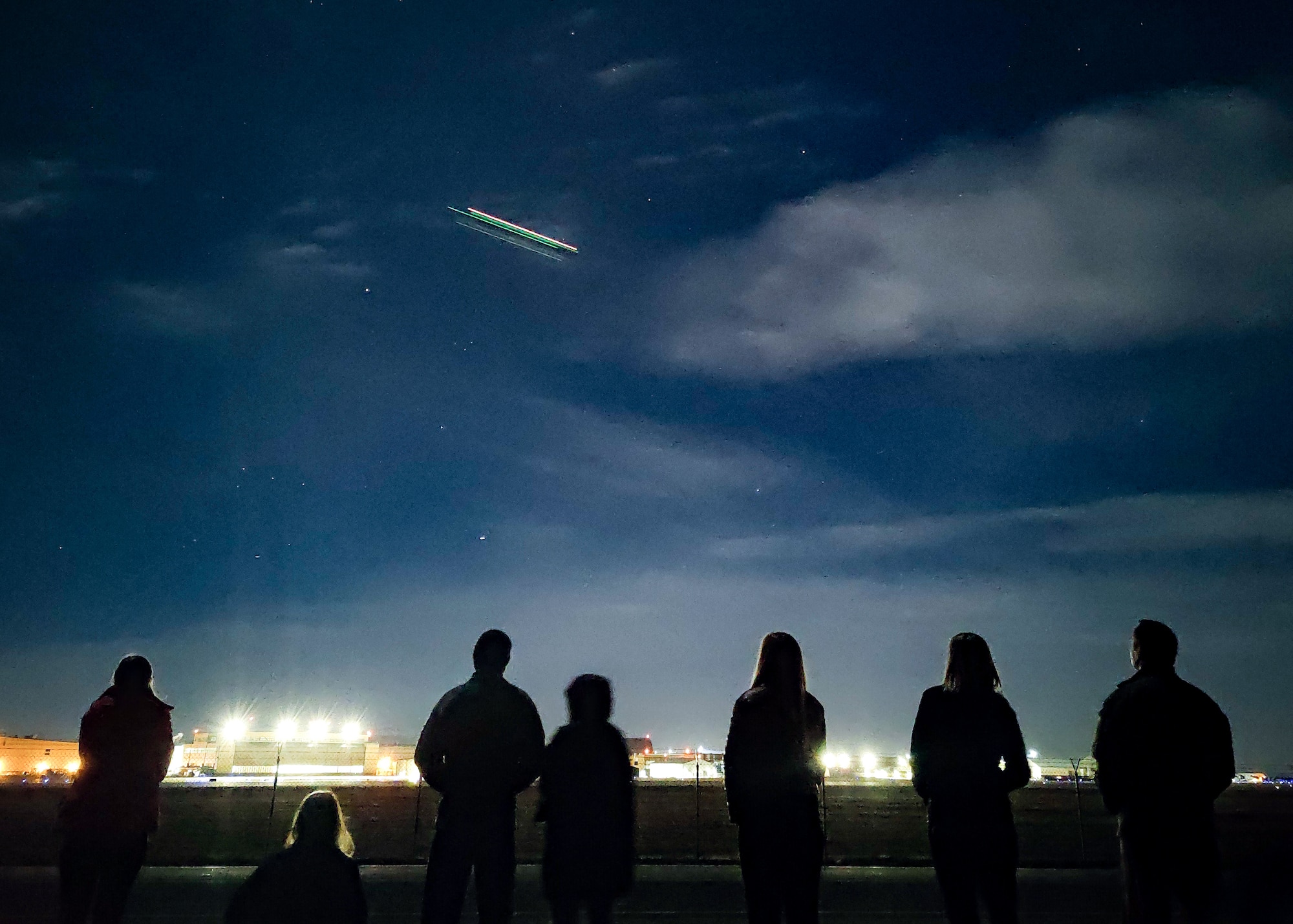 a photo of family members watching a take off