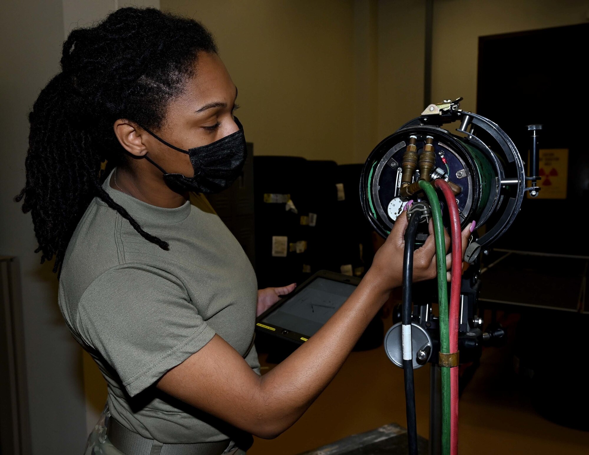 Senior Airman Treashear Britt, a nondestructive inspection technician with the 908th Maintenance Squadron, plugs in a chord to the x-ray imaging system.