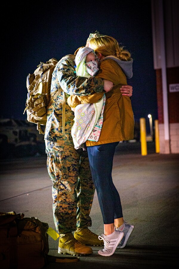 A U.S. Marine with 2d Battalion, 8th Marine Regiment, 2d Marine Division, hugs his family during a homecoming on Camp Lejeune, North Carolina, Feb. 14, 2021.