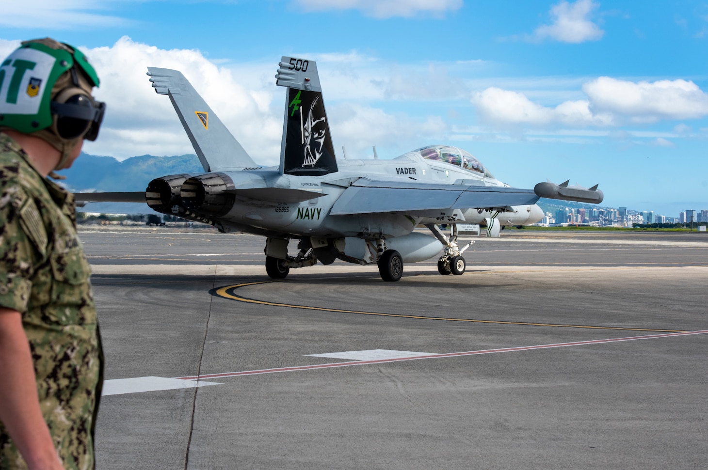 A U.S. Navy EA-18G Growler aircraft assigned to Electronic Attack Squadron 209, Naval Air Station Whidbey Island, Wash., prepares for flight during a joint exercise Jan. 25, 2022, Joint Pearl Harbor-Hickam, Hawaii. The exercise provides participants with a multi-faceted, collaborative venue with supporting infrastructure and personnel. (U.S. Air National Guard photo by Master Sgt. Mysti Bicoy)