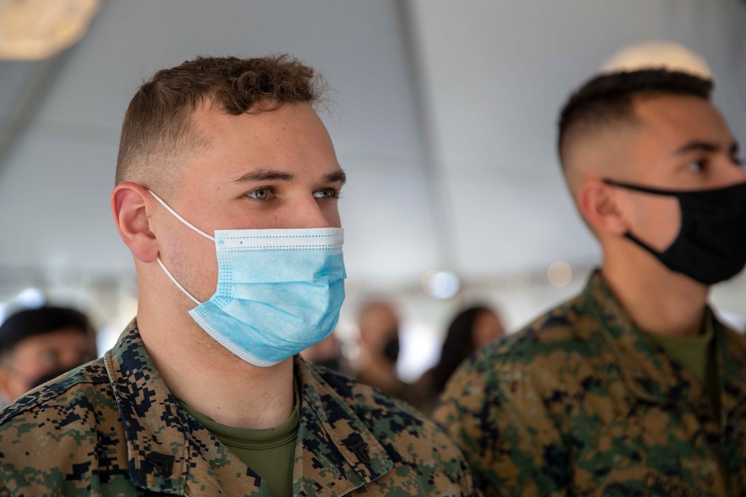 U.S. Marine Corps Cpl. Justin Burd, a financial technician with Marine Corps Base Quantico Security Company, stands at attention while the national anthem is played during the opening ceremony of a new United Service Organization (USO) building at Marine Corps Base Quantico, Virginia, Feb. 15 2022. The new location has been dedicated to video game entertainment and houses state of the art gaming equipment. The opening of this USO location marks the second location established on Quantico to allow Marines easier access to the serviced provided by the USO. (U.S. Marine Corps photo by Staff Sgt. Victoria Ross)