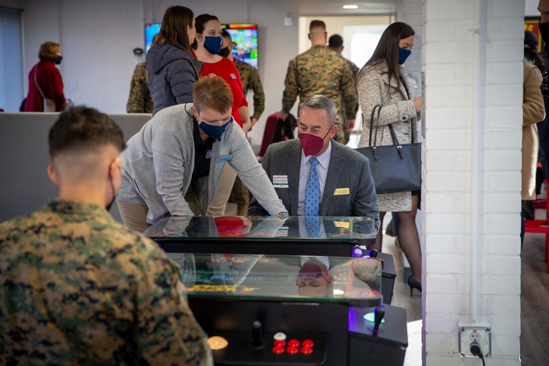 U.S. Marines and civilian supporters play video games available at the new United Service Organization (USO) building at Marine Corps Base Quantico, Virginia, Feb. 15 2022. The new location has been dedicated to video game entertainment and houses state of the art gaming equipment. The opening of this USO location marks the second location established on Quantico to allow Marines easier access to the serviced provided by the USO. (U.S. Marine Corps photo by Staff Sgt. Victoria Ross)