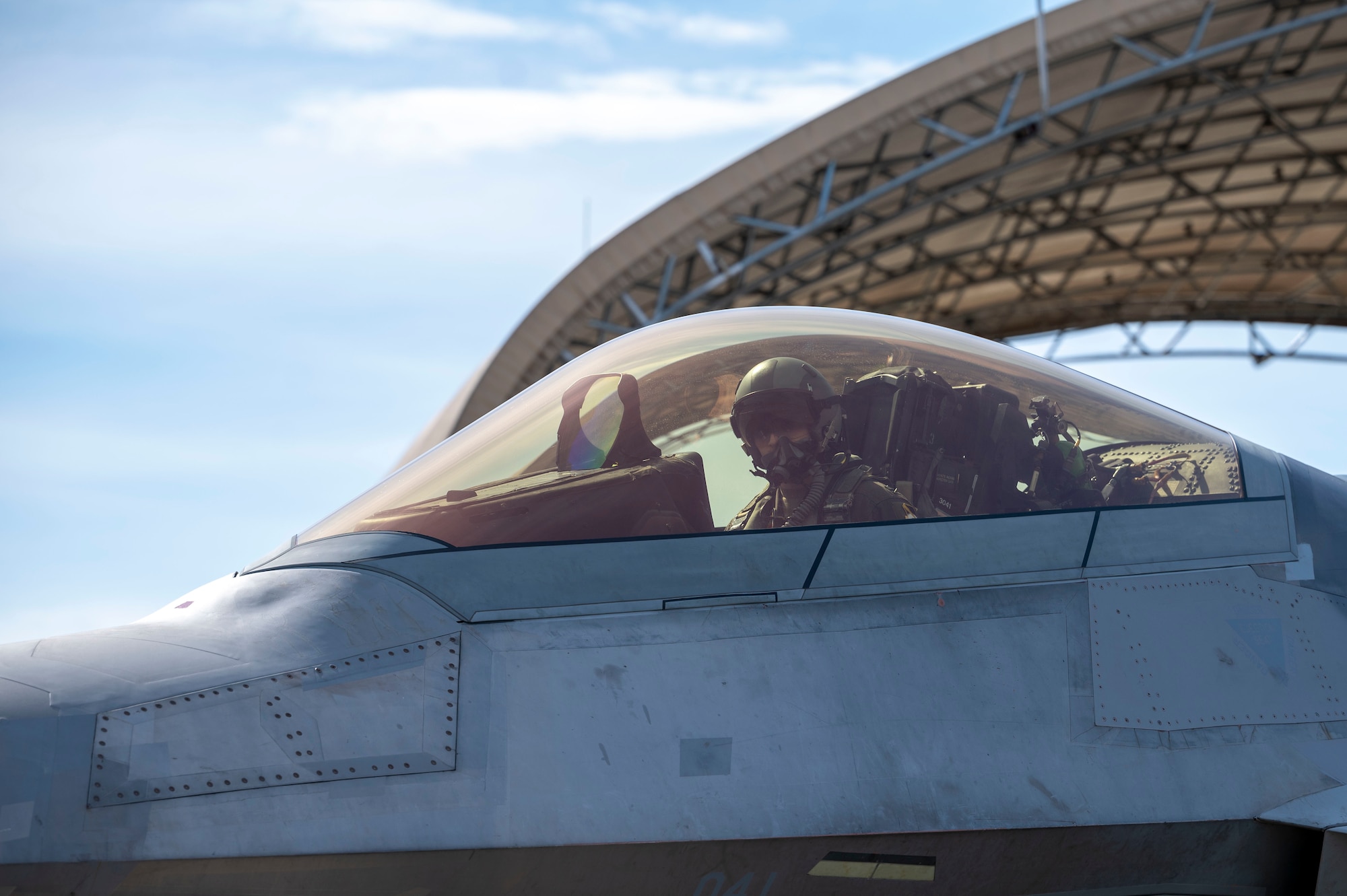An F-22 Raptor taxis on a runway