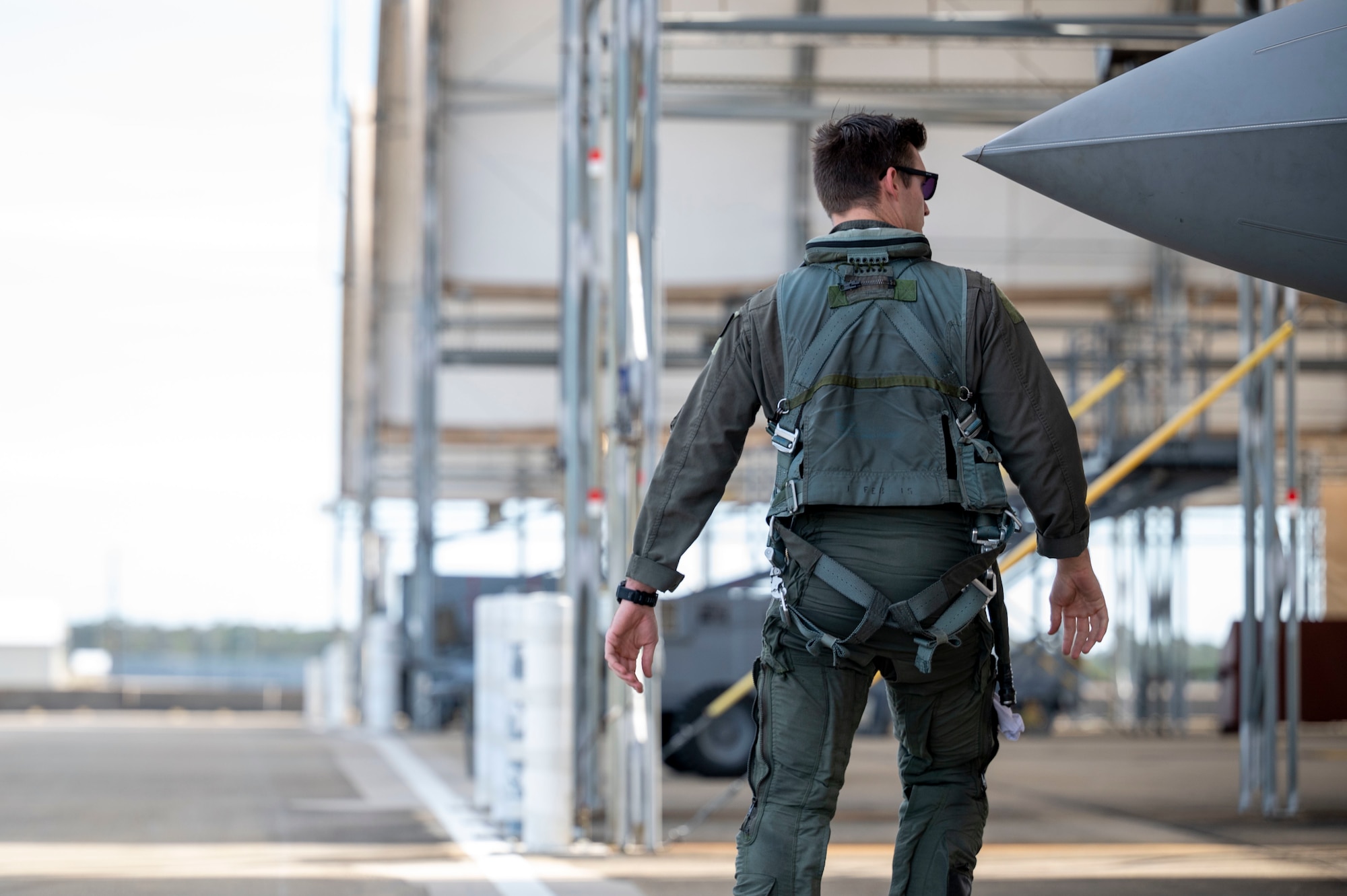 A pilot looks at the exterior of an aircraft