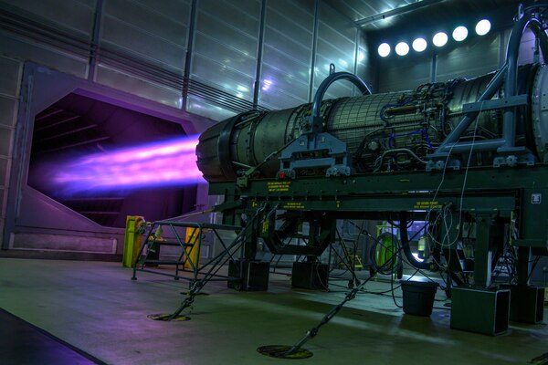 An aircraft jet engine emits a blue flame.