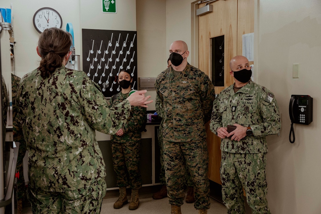 U.S. Marine Corps Sgt. Maj. Troy E. Black, the 19th Sergeant Major of the Marine Corps, and the Master Chief Petty Officer of the Navy Russell Smith, receive a capabilities brief at Air Force Mortuary Affairs Operations, Dover Air Force Base, Dover, Delaware, Feb. 8, 2022. The Sergeant Major of the Marine Corps conducted the visit to thank the service members responsible for receiving and caring for fallen service members. The Armed Forces Medical Examiner System provides the Department of Defense and other federal agencies comprehensive forensic investigative services, to include forensic pathology, DNA Forensics, forensic toxicology, and medical mortality surveillance. (U.S. Marine Corps photo by Staff Sgt. Victoria Ross)