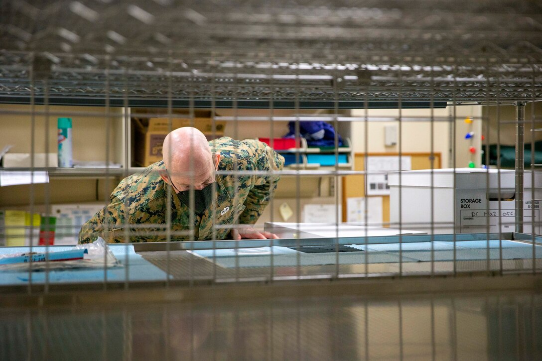 U.S. Marine Corps Sgt. Maj. Troy E. Black, the 19th Sergeant Major of the Marine Corps, views items recovered from an individual upon their arrival at Armed Forces Medical Examiner System, Dover Air Force Base, Dover, Delaware, Feb. 8, 2022. The Sergeant Major of the Marine Corps conducted the visit to thank the service members responsible for receiving and caring for fallen service members. The Armed Forces Medical Examiner System provides the Department of Defense and other federal agencies comprehensive forensic investigative services, to include forensic pathology, DNA Forensics, forensic toxicology, and medical mortality surveillance. (U.S. Marine Corps photo by Staff Sgt. Victoria Ross)