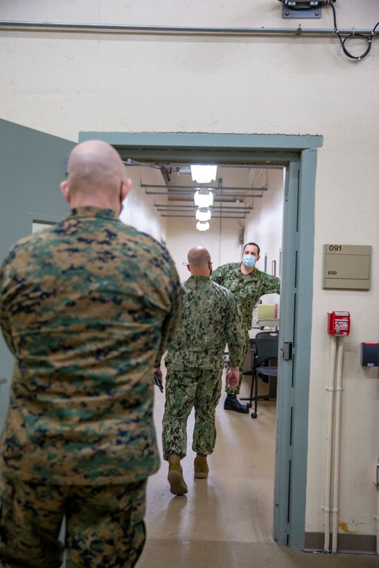 U.S. Marine Corps Sgt. Maj. Troy E. Black, the 19th Sergeant Major of the Marine Corps, and the Master Chief Petty Officer of the Navy Russell Smith, tour Air Force Mortuary Affairs Operations at Dover Air Force Base, Dover, Delaware, Feb. 8, 2022. The Sergeant Major of the Marine Corps conducted the visit to thank the service members responsible for receiving and caring for fallen service members. The Armed Forces Medical Examiner System provides the Department of Defense and other federal agencies comprehensive forensic investigative services, to include forensic pathology, DNA Forensics, forensic toxicology, and medical mortality surveillance. (U.S. Marine Corps photo by Staff Sgt. Victoria Ross)