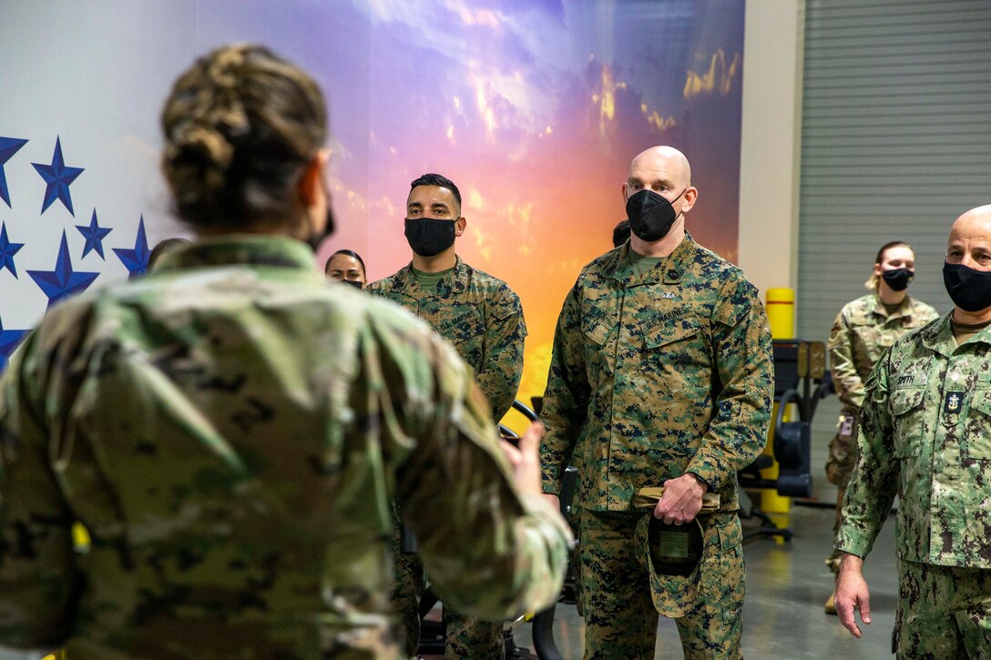 U.S. Marine Corps Sgt. Maj. Troy E. Black, the 19th Sergeant Major of the Marine Corps, and the Master Chief Petty Officer of the Navy Russell Smith, speak to Air Guardsmen serving at Air Force Mortuary Affairs Operations at Dover Air Force Base, Dover, Delaware, Feb. 8, 2022. The Sergeant Major of the Marine Corps conducted the visit to thank the service members for their commitment to ensuring dignity, honor and respect to fallen service members and their families. Air Force Mortuary Affairs Operations provides global contingency mortuary response teams in support of Air Force and combatant command requirements, supporting both an Air Force and joint role. (U.S. Marine Corps photo by Staff Sgt. Victoria Ross)