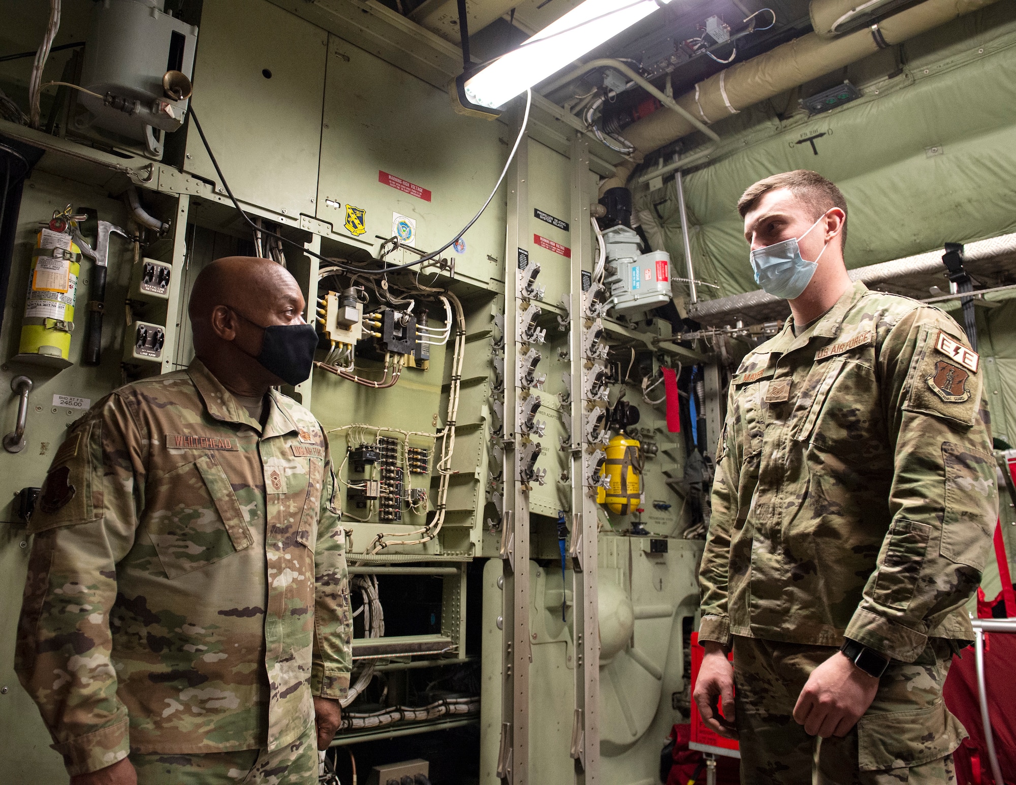 U.S. Air Force Tech. Sgt. Kyle Mayer, an electro and environmental specialist, 133rd Maintenance Squadron, right, speaks to Senior Enlisted Advisor Tony L. Whitehead, senior enlisted advisor to the chief, National Guard Bureau in St. Paul, Minn., Feb. 16, 2022.