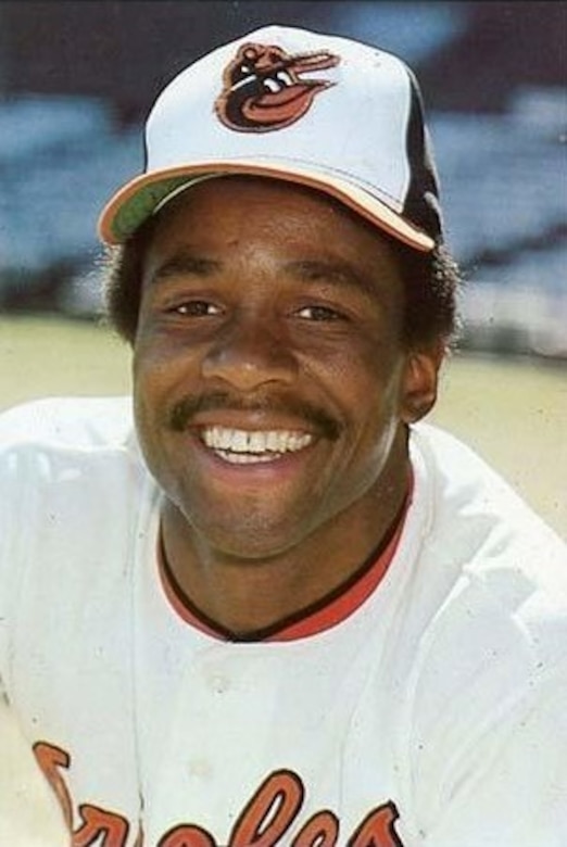 A baseball player in an Orioles uniform, smiles.
