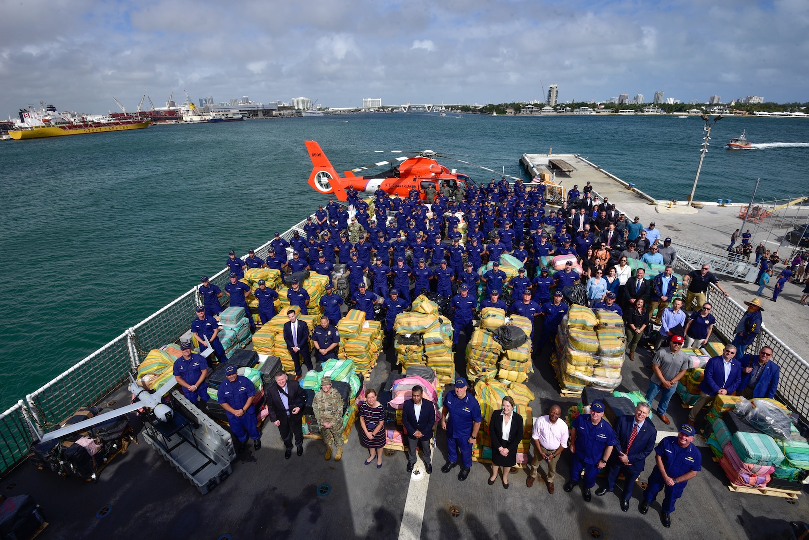 Group photo of Coast Guard personnel posing with $1.06 billion in illegal narcotics.