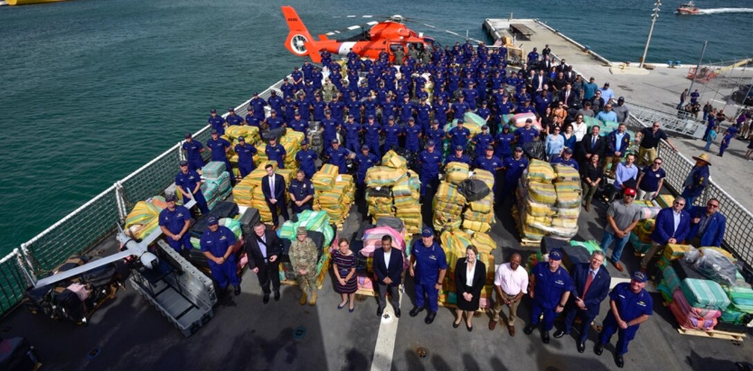 Group photo of Coast Guard personnel posing with $1.06 billion in illegal narcotics.
