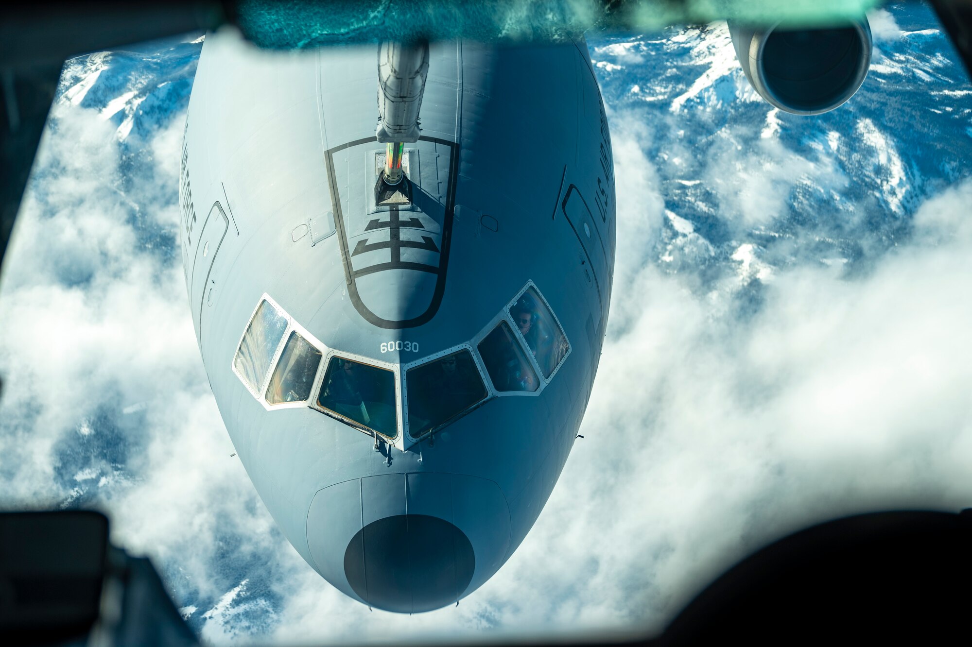 A plane gets refueled in the sky