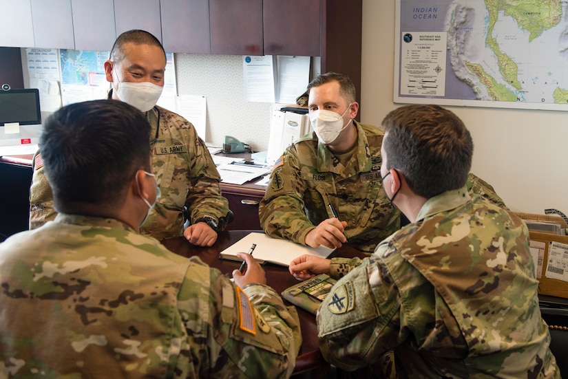 U.S. Army Reserve Maj. Gene Choi, and Lt. Col Benjamin Flosi, along with their Infrastructure and Economics teammates on the 38G Government Functional Specialty Team, 351st Civil Affairs Command, U.S. Army Civil Affairs and Psychological Operations Command (Airborne), conduct a mini-working group prior to a partnership meeting during Keen Edge 22, Camp Smith, Hawaii.