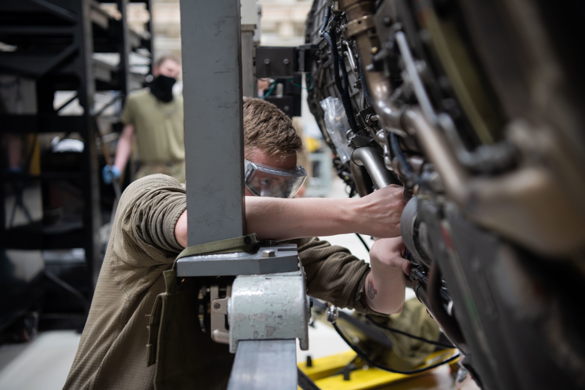 An Airman works on an engine.